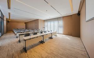 an empty lecture room with rows of tables and chairs at Intercity Hotel & Serviced Apartment Phnom Penh Downtown in Phnom Penh +67 photos