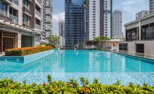 a large swimming pool in a city with tall buildings at Intercity Hotel & Serviced Apartment Phnom Penh Downtown in Phnom Penh