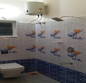 a bathroom with a shower with blue and white tiles at Kodai Elegance in Kodaikānāl +49 photos
