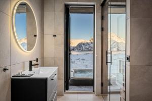 a bathroom with a sink and a large window at New designer cabin in Lofoten in Storøya +22 photos
