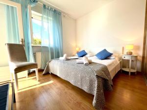 a bedroom with a bed and a chair and a window at Villa Sarah in Selca