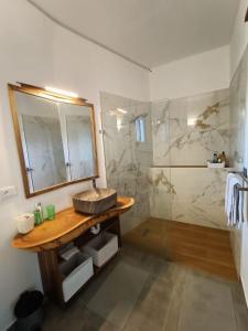 a bathroom with a sink and a mirror and a shower at Apartment Mariquita in Las Terrenas