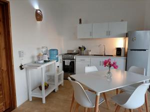 a kitchen with a white table and white appliances at Apartment Mariquita in Las Terrenas