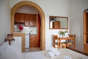 a kitchen and a dining room with a table and a kitchen at Irene Studios Patmos in Skala
