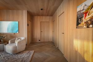 a living room with a chair and a door at Secluded Lodge - Stunning Views! in Storøya