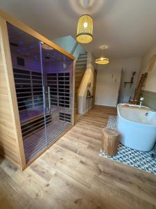 a large bathroom with a tub and a window at L Entre Deux Époques in Pré-en-Pail +113 photos