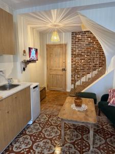 a kitchen with a sink and a table in a room at L Entre Deux Époques in Pré-en-Pail