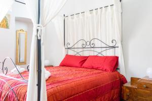 a bedroom with a bed with a red bedspread at Casa di Nonna Nì - Due alloggi con scala interna condivisa in Portocannone