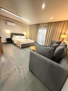 a living room with a bed and a couch at SABBAL apartments in Salamina