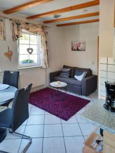 a living room with a couch and a table at Haus Petra in Gleishorbach