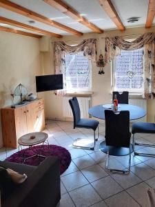 a living room with a table and chairs and a tv at Haus Petra in Gleishorbach