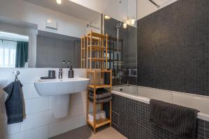 a bathroom with a sink and a bath tub at GreenVista 20 minutes by Therme & Airport in Voluntari +34 photos