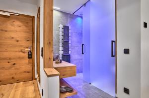 a bathroom with a walk in shower and a sink at Resort Hotel Bodenmais in Bodenmais
