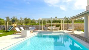 a swimming pool in a backyard with a patio furniture and a swimming poolvisor at Villa Corsa by Villas Guide in Barban