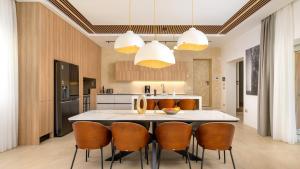 a kitchen with a large white table and chairs at Villa Corsa by Villas Guide in Barban