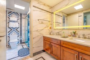 a bathroom with a sink and a shower at 悦江阁美宿 in Chongqing