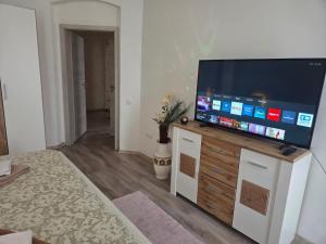 a living room with a flat screen tv on a cabinet at 3 Apartments Angels o k b in Altenburg