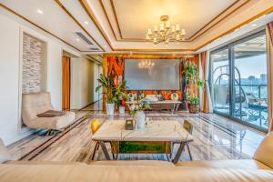 a living room with a tv and a table at 悦江阁美宿 in Chongqing
