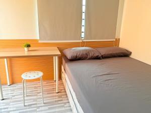a small bedroom with a bed and a desk at Santiago City Transient House in Santiago