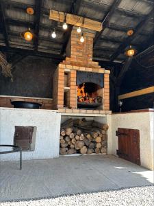 a brick oven with a fire inside of it at Flow House in Satu Mare