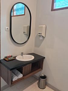 a bathroom with a sink and a mirror at INDO ALAM RECREATIONAL RESORT in Sindanglaya