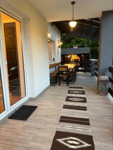 a porch with a table and chairs and a patio at Flow House in Satu Mare