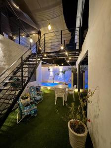a room with a staircase and a table and chairs at Serenity Elegance Suite PB in Mérida