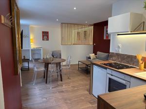 a kitchen and living room with a table and a dining room at Le Martini in Chalon-sur-Saône