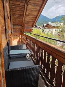 a balcony with chairs and a view of the mountains at Resi's Kitz Lodge in Kitzbühel