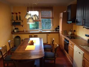 eine Küche mit einem Holztisch und Stühlen in der Unterkunft Apartment Rothehof in Petershagen