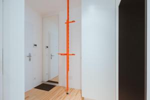 an empty room with a cross on the wall at Coho Slowliving in Linz +42 photos