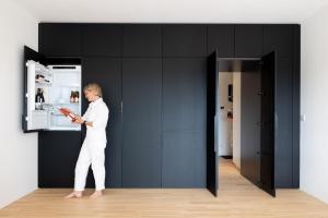 a woman standing in a room with a book at Coho Slowliving in Linz