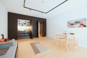 a living room with a table and a dining room at Coho Slowliving in Linz