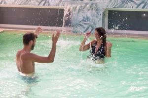 a man and a woman playing in a fountain at Hotel Romagna in Cattolica