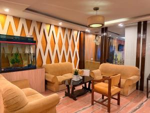 a waiting room with chairs and a fish tank at Hotel Tenki Kathmandu in Kathmandu