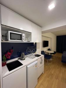 a kitchen with a microwave and a stove top oven at Orbi city bloke A in Angisa