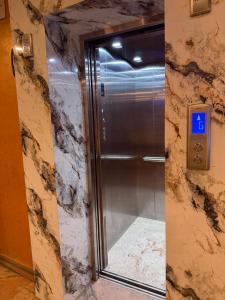 a elevator in a hotel room with a glass door at Hotel Tenki Kathmandu in Kathmandu +19 photos