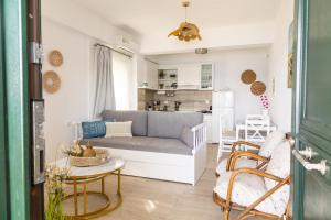 a living room with a couch and a kitchen at The litlle mermaid in Amaliapoli