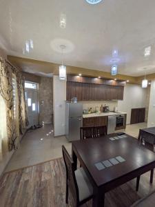 a kitchen and a dining room with a table and chairs at Наслада in Panagyurishte