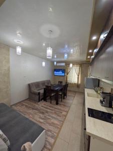 a kitchen and living room with a couch and a table at Наслада in Panagyurishte