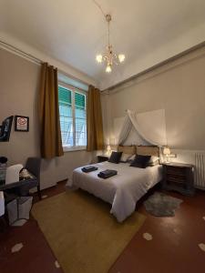 a bedroom with a large bed and a window at Guest House Santa Giustina Lucca Centro Storico in Lucca