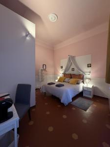 a bedroom with a bed and a table and a chair at Guest House Santa Giustina Lucca Centro Storico in Lucca +35 photos