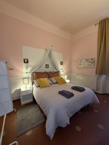 a bedroom with a large bed with yellow pillows at Guest House Santa Giustina Lucca Centro Storico in Lucca