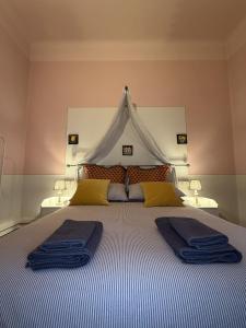 a bedroom with a large bed with two pillows on it at Guest House Santa Giustina Lucca Centro Storico in Lucca