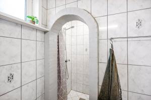 a bathroom with a shower with a glass door at Feriehus Oluf in Ålbæk +15 photos