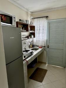a small kitchen with a sink and a refrigerator at Peaceful Place 1 in Nairobi