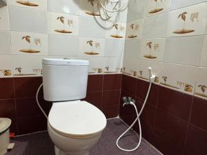 a bathroom with a toilet with a hose at Townhouse 4bhk Bungalow - TIE Hotels in Pondicherry +37 photos