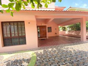 a house with a pathway leading to the front door at Townhouse 4bhk Bungalow - TIE Hotels in Pondicherry