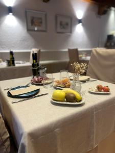 a white table with plates of food on it at Hostal La Placeta in Camprodon +39 photos
