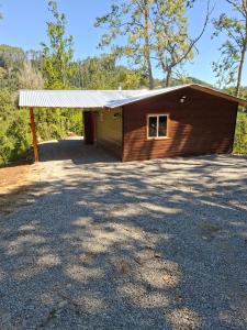 a small wooden building with a garage at cabaña los ulmos in Lago Ranco +9 photos